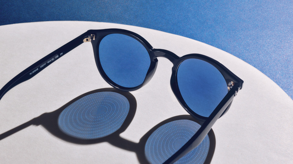 A pair of sunglasses cast a long shadow in the sun – the shadow of the lenses displays the circular pattern of the myopia management lens