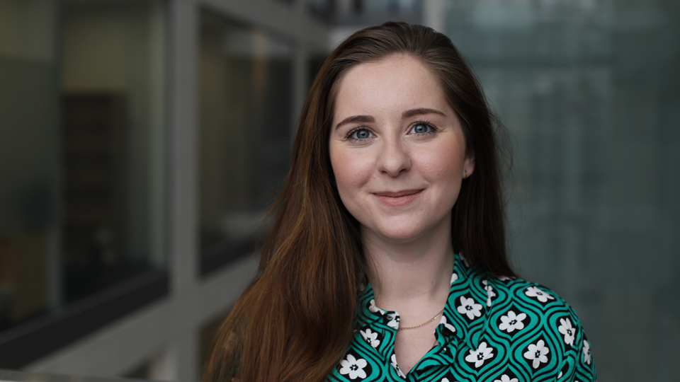 Dr Bethany Higgins is pictured wearing a green and white patterned top