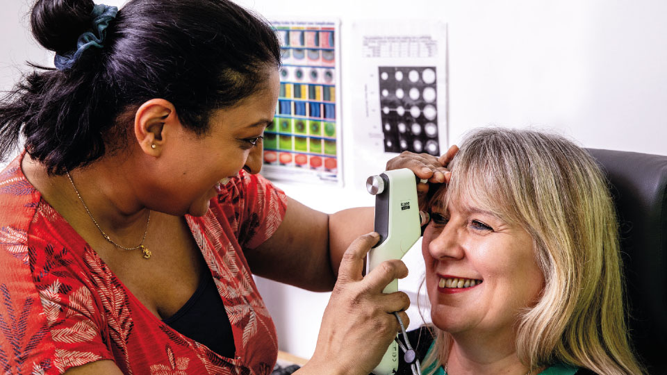 Optometrist Bhavina Patel examines a patient