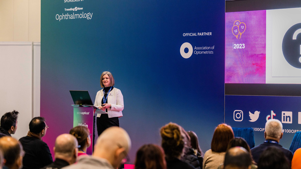 Liz Lumb presents on stage at 100% Optical      