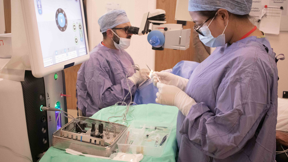 Clinicians in a surgical environment performing a cataract surgery