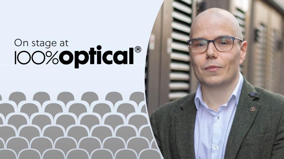 A headshot of Dr Peter Hampson is on the right hand side of the image, which has a grey and light blue template and the words 'On stage at 100% Optical'