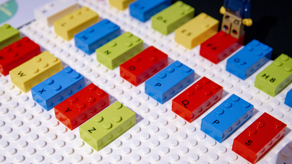 Yellow and red Lego braille bricks displayed on a table at the RNIB Braille 200 event 