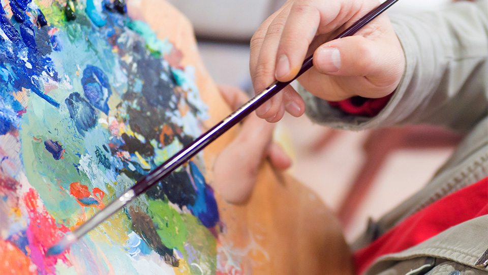 Artist mixing paints