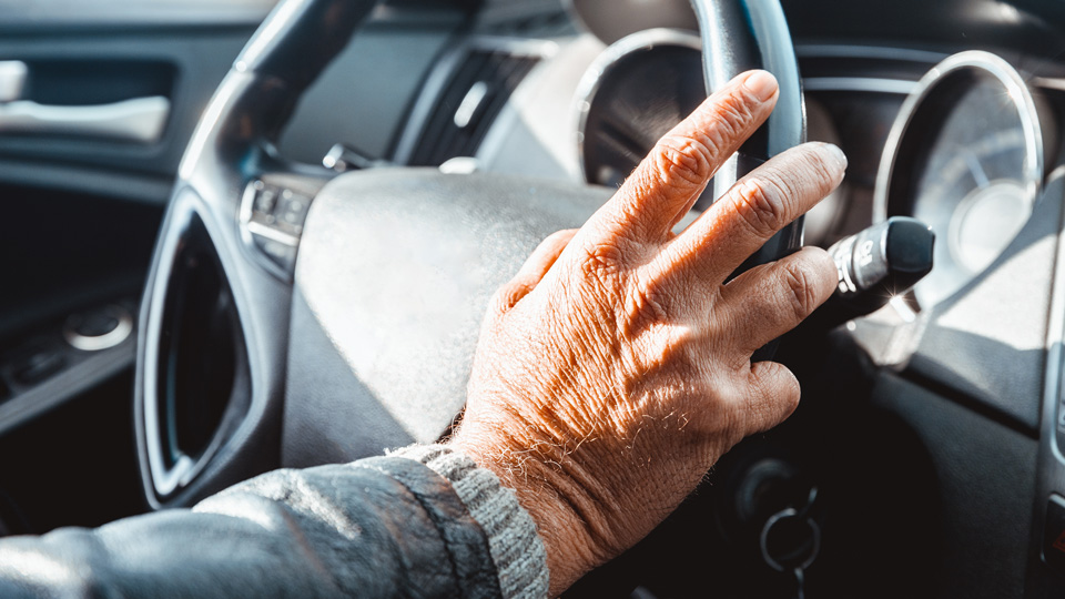 hand on steering wheel