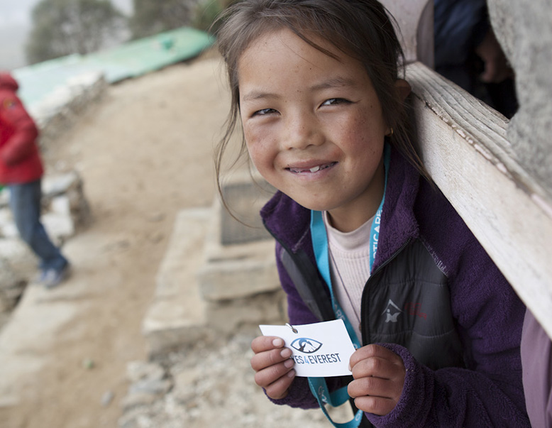 Eyes4Everest – A little girl holds an Eyes4Everest card