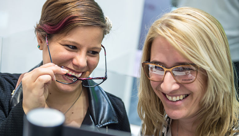 Women trying on glasses