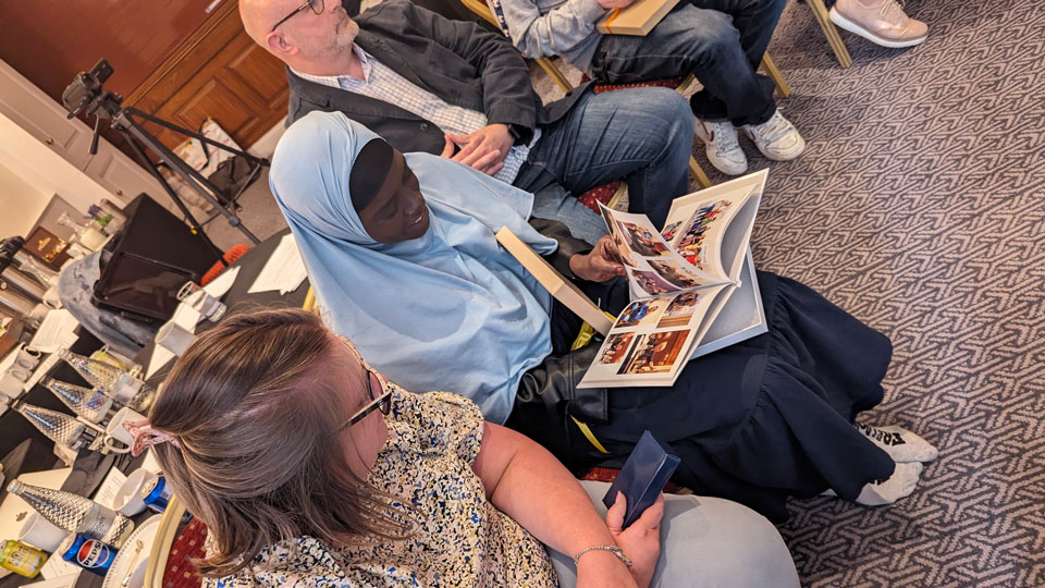 People sitting in room on chairs 