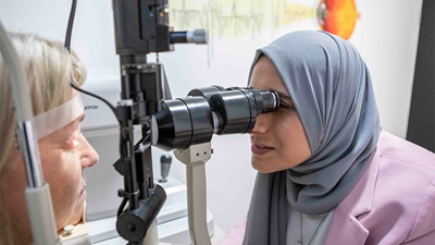 Optometrist examining patients eyes