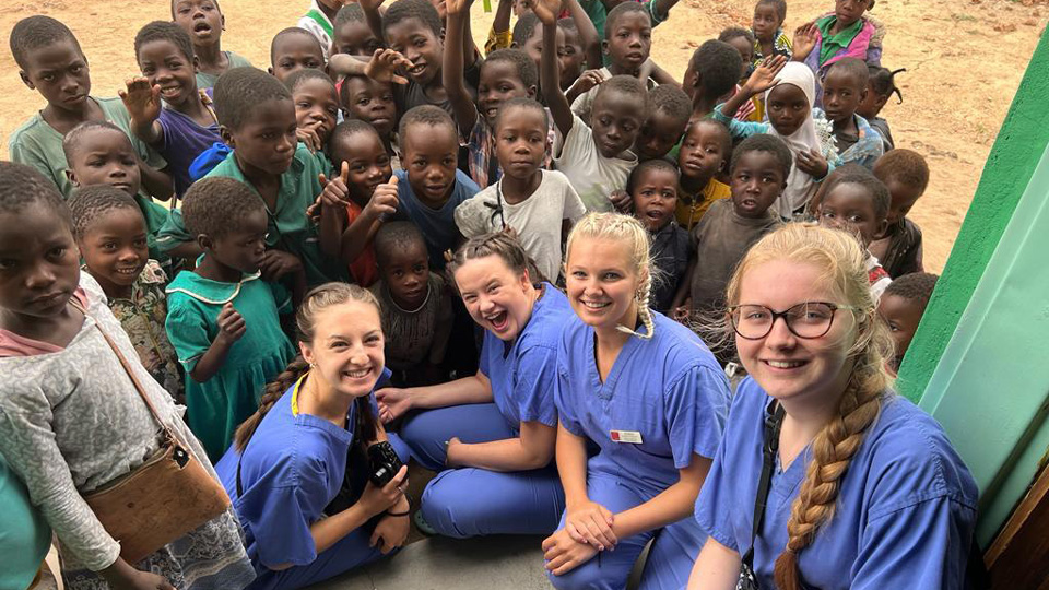 Cardiff students with a large group of children in Malawi