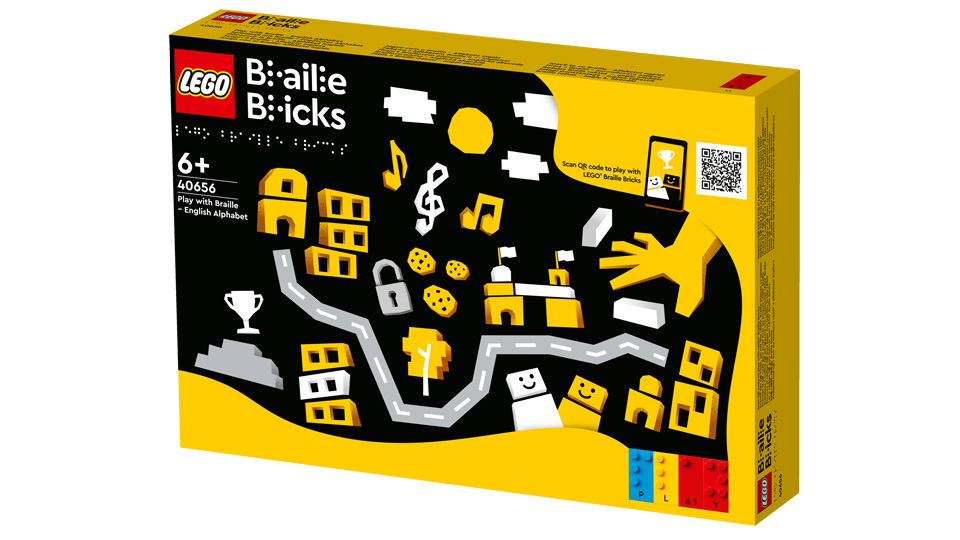 The Lego Braille Bricks box with cartoon illustrations of music notes, a giant hand, buildings, and people